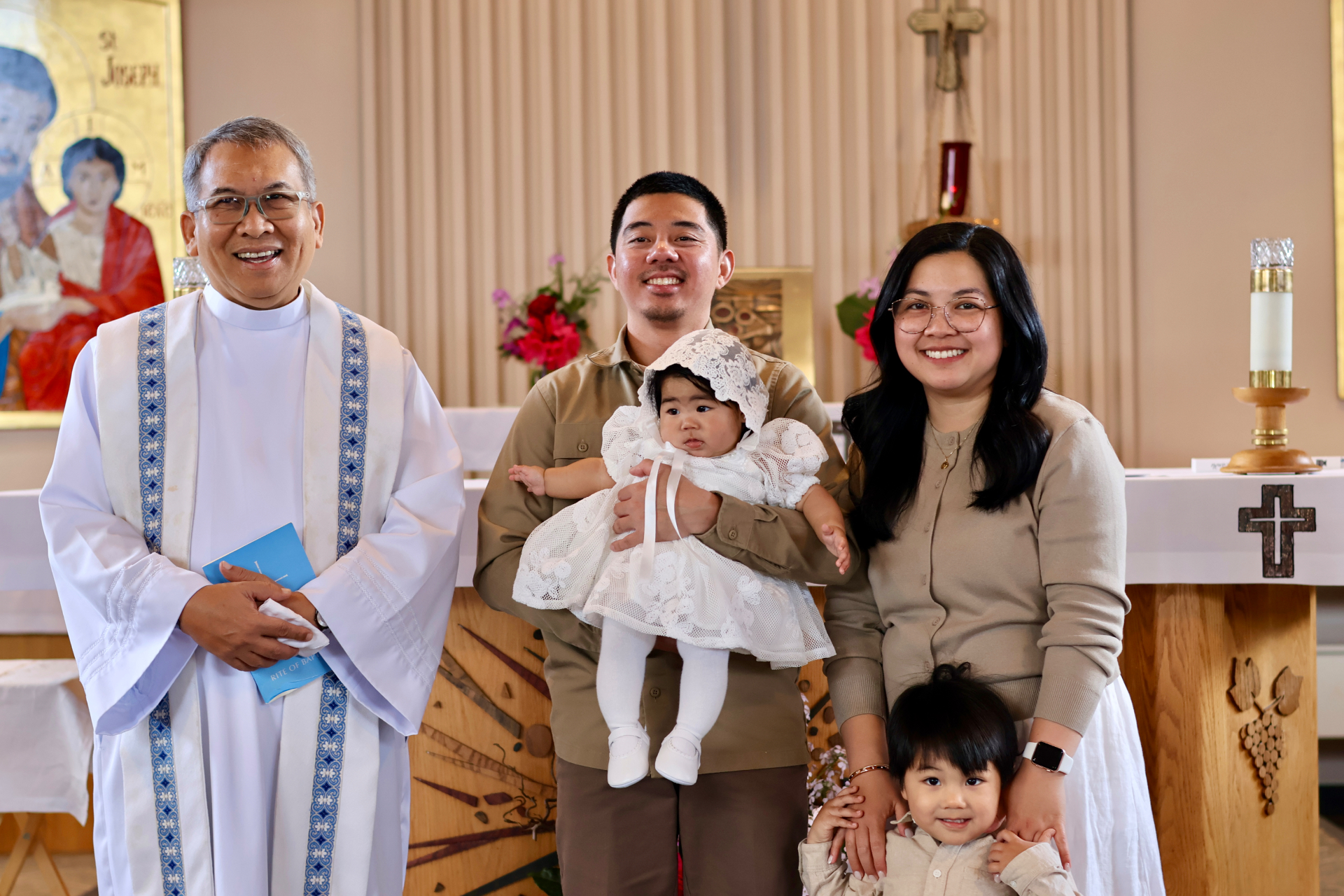 Baptism portrait with family and priest